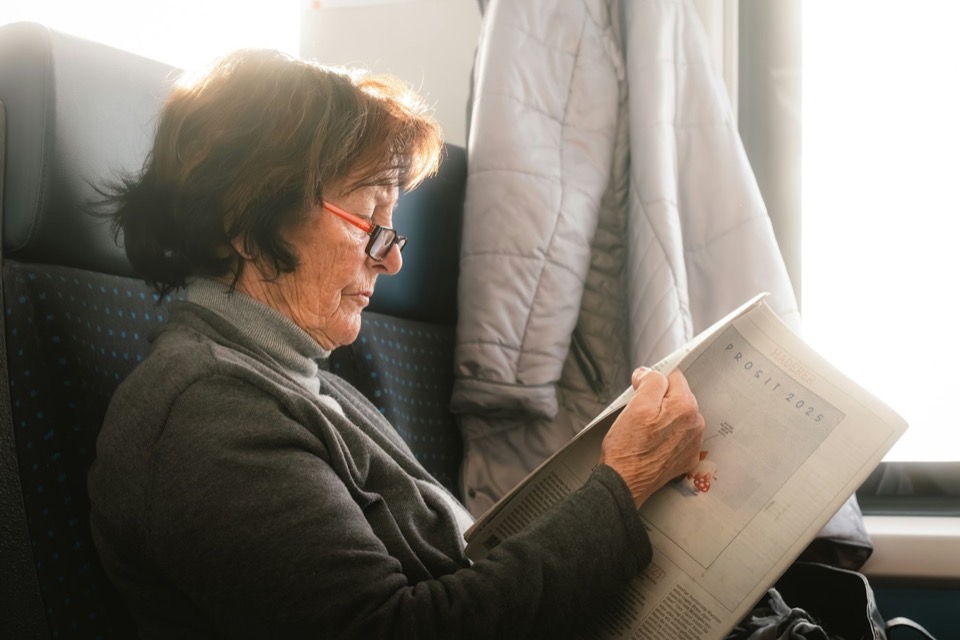 An older woman reading through a document